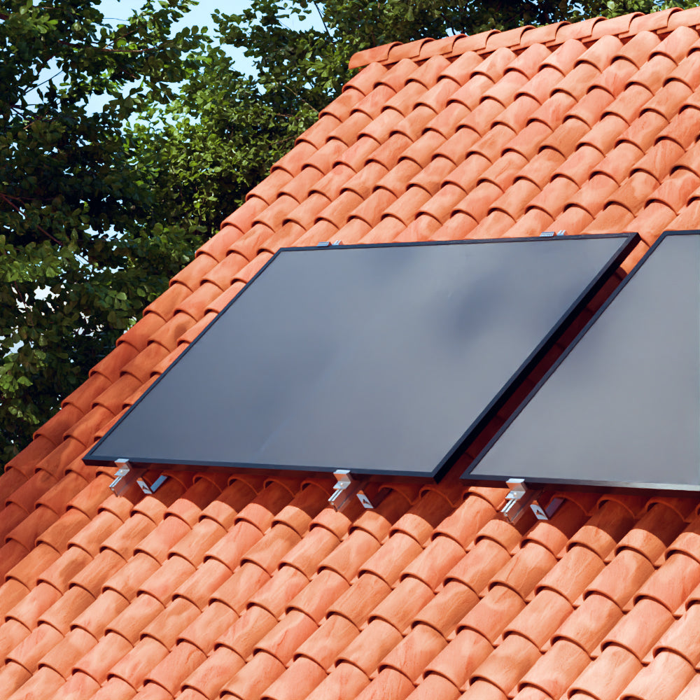 Solar panels installed on a terracotta tile roof – Paneles solares instalados en un tejado de tejas de terracota